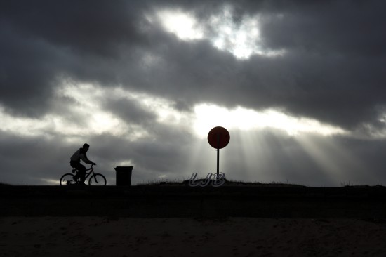 Cycling along Blyth South Beach Promenade, Northumberland Coast.