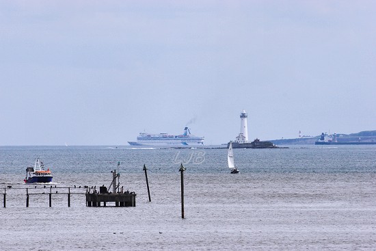 View from North Blyth with st. Mary's Lighthouse and a ship approaching the River Tyne in the distance.