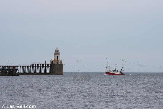 Fishing boat passing Blyth Lighthouse.