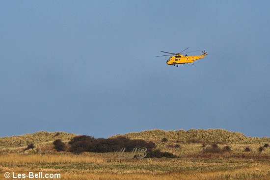 Helicopter above the dunes at Druridge Bay.