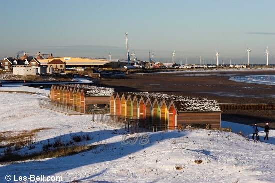 Beach huts in the snow.