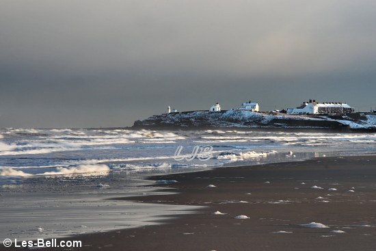 Foam on the beach at Seaton Sluice.