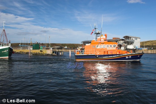 Eyemouth Lifeboat towing a fishing boat into the harbour.