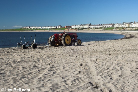 Tractor and trailer on the beach at Newbiggin, Northumberland.
