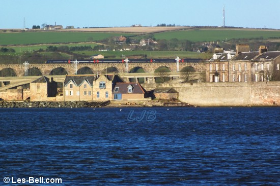 View along the River Tweed to the bridges where a train was entering Berwick Station.