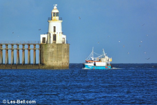 Fishing boat passing Blyth Lighthouse.