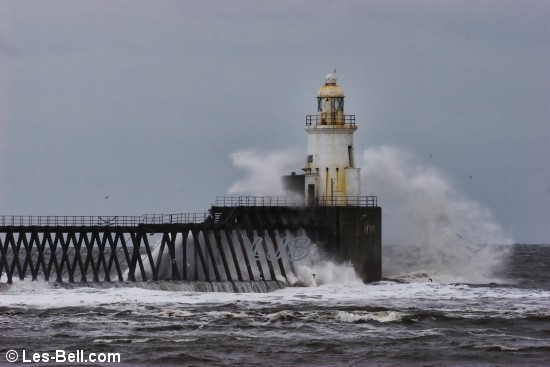 Waves breaking over the lighthouse at Blyth on the Northumberland Coast.