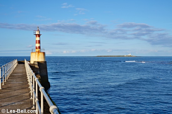 Navigation light at the end of Amble Pier, with Coquet Island in the distance..
