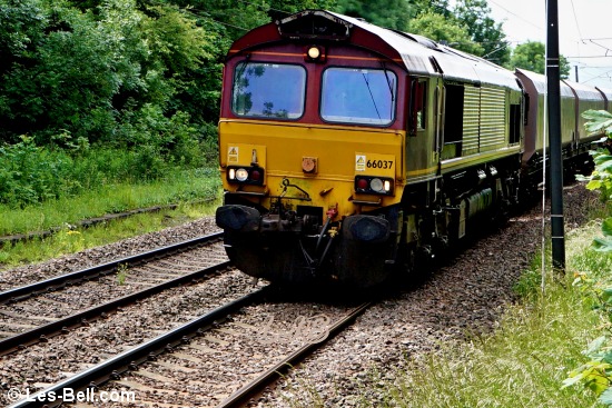 Class 66 diesel hauling a freight train at Pegswood Station.