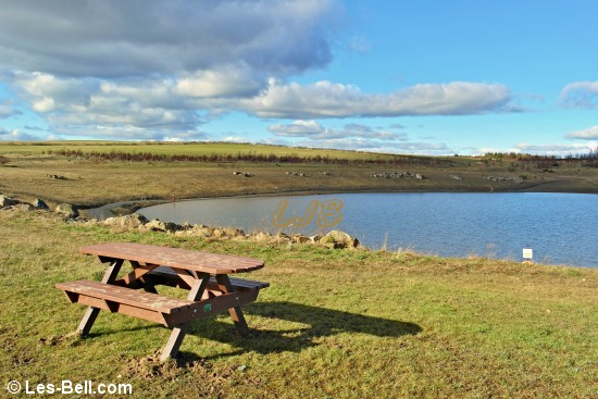 New picnic benches beside the lake at Pegswood Country Park near Morpeth.