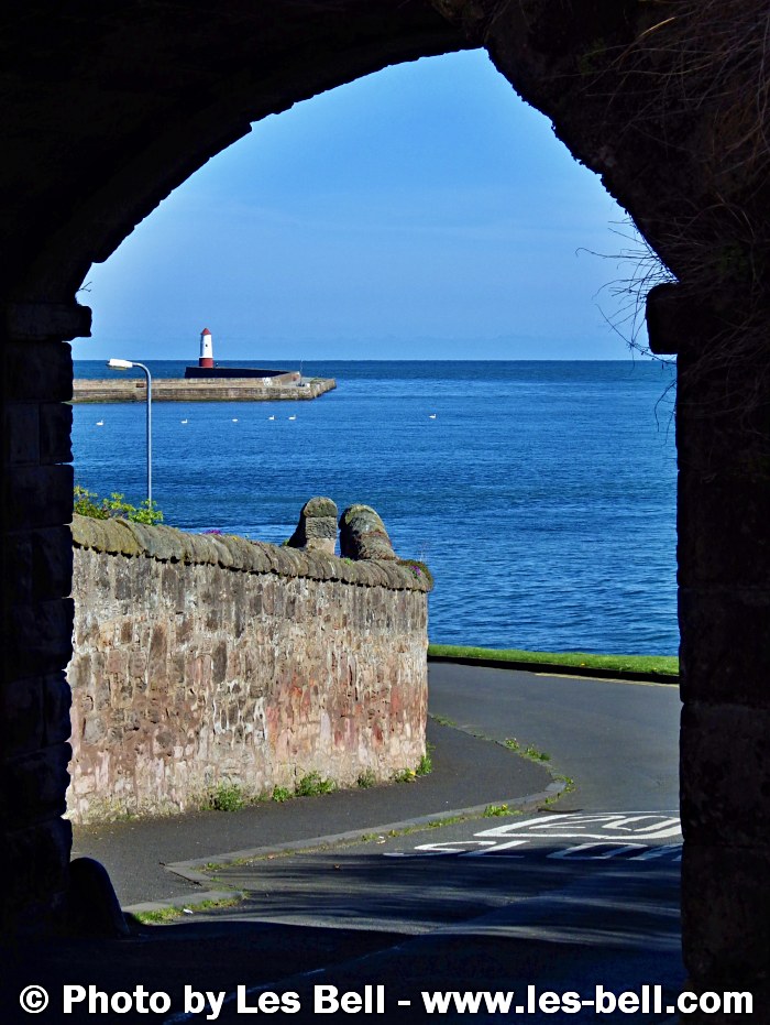 View through Ness Gate to the River Tweed, pier and lighthouse at Berwick on the Northumberland Coast..