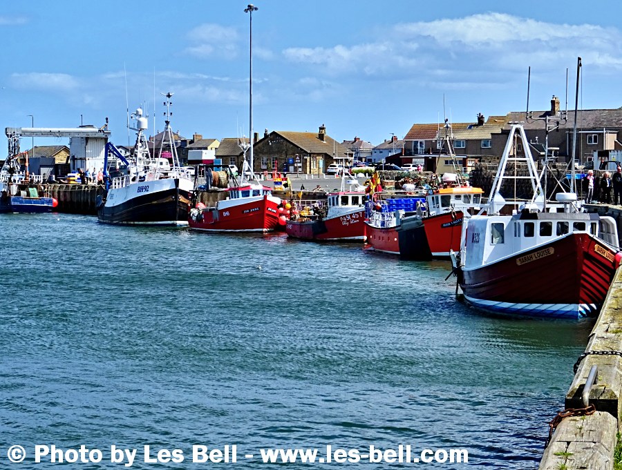 Fishing boats moored at the quayside at Amble on the Northumberland Coast.