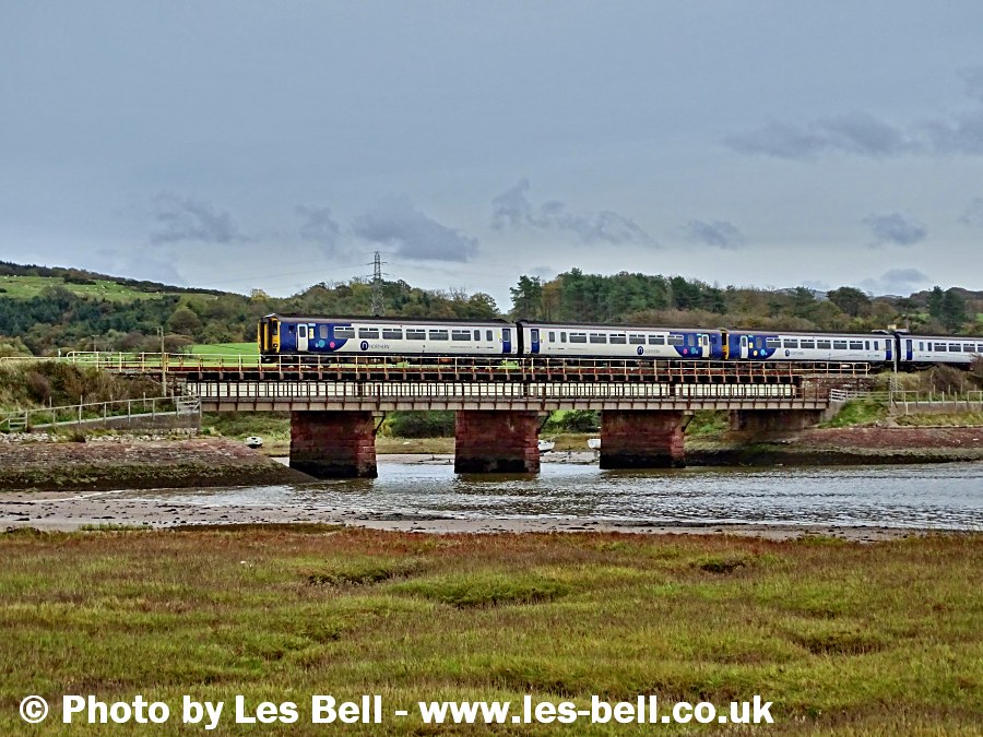 Passenger train crossing the viaduct at Ravenglass, Cumbria Coast.