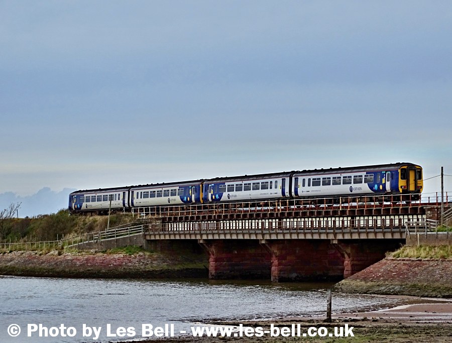 Passenger train crossing the viaduct at Ravenglass, Cumbria Coast.